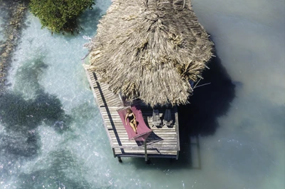 Overwater bungalow at private island Thatch Caye Resort _ Belize Retreats