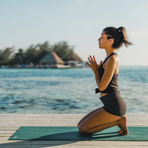 Retreat leader meditating on the private island Thatch Caye _ Belize Retreats