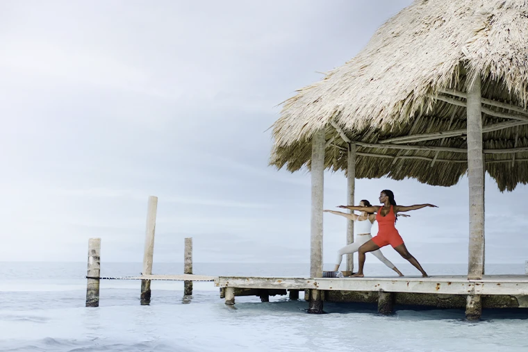 Yoga and wellness on an overwater palapa on a private island Thatch Caye with crystal clear water _ Belize Retreats